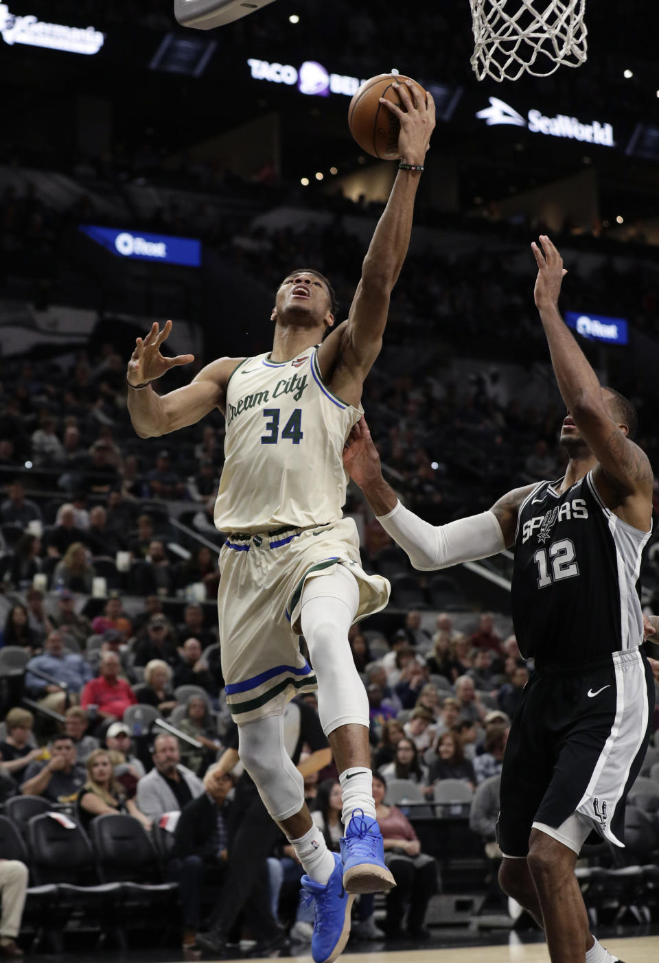 Milwaukee Bucks forward Giannis Antetokounmpo (34) shoots past San Antonio Spurs center LaMarcus Aldridge (12) during the second half of an NBA basketball game in San Antonio, Monday, Jan. 6, 2020. (AP Photo/Eric Gay)