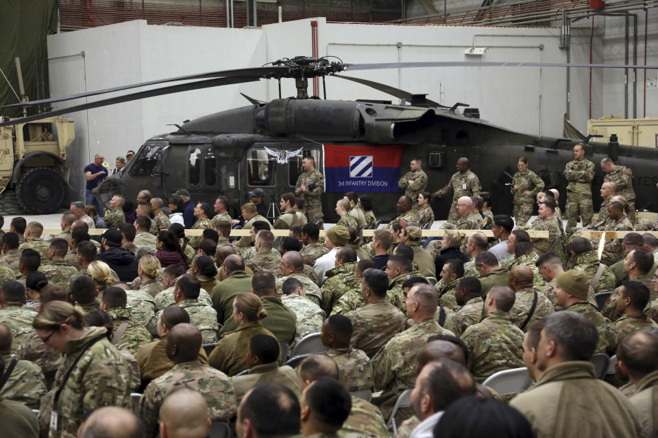 FILE- in this Sunday, Dec. 24, 2017, photo, Members of the U.S. military attend a ceremony on Christmas Eve at a U.S. airfield in Bagram, north of Kabul, Afghanistan. The U.S. military has begun shipping equipment and winding down contracts with local service providers ahead of the May 1 start of the final phase of its military pullout from Afghanistan, a U.S. Defense Department official said Thursday, April 22, 2021. (AP Photo/Rahmat Gul, File)