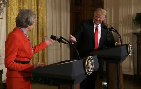 U.S. President Donald Trump and British Prime Minister Theresa May gesture at one another as they hold a joint news conference at the White House in Washington, U.S., January 27, 2017. REUTERS/Carlos Barria