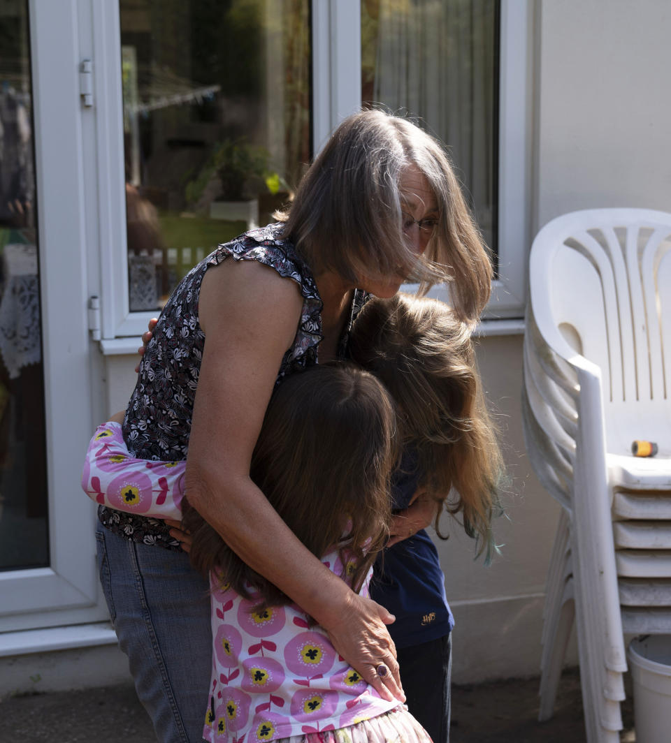 RETRANSMITTING ADDING AGES SURNAMES NOT GIVEN Susan reunited with her grandchildren Emily 10 (right) and Daisy 7 (left), in Ashtead, Surrey, for the first time following the introduction of measures to bring England out of lockdown, as people living alone in England can form support bubbles with other households from Saturday, ending weeks of isolation under lockdown.