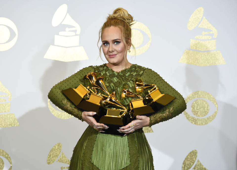 FILE - Adele poses in the press room with the awards for album of the year for "25," song of the year for "Hello," record of the year for "Hello," best pop solo performance for "Hello," and best pop vocal album for "25" at the 59th annual Grammy Awards on Feb. 12, 2017, in Los Angeles. The singer turns 33 on May 5. (Photo by Chris Pizzello/Invision/AP, File)