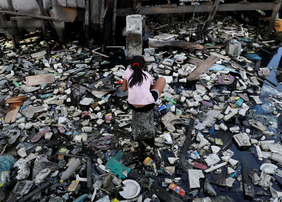 A girl plays in a garbage-filled river in Navotas, metro Manila, Philippines January 15, 2018. REUTERS/Dondi Tawatao