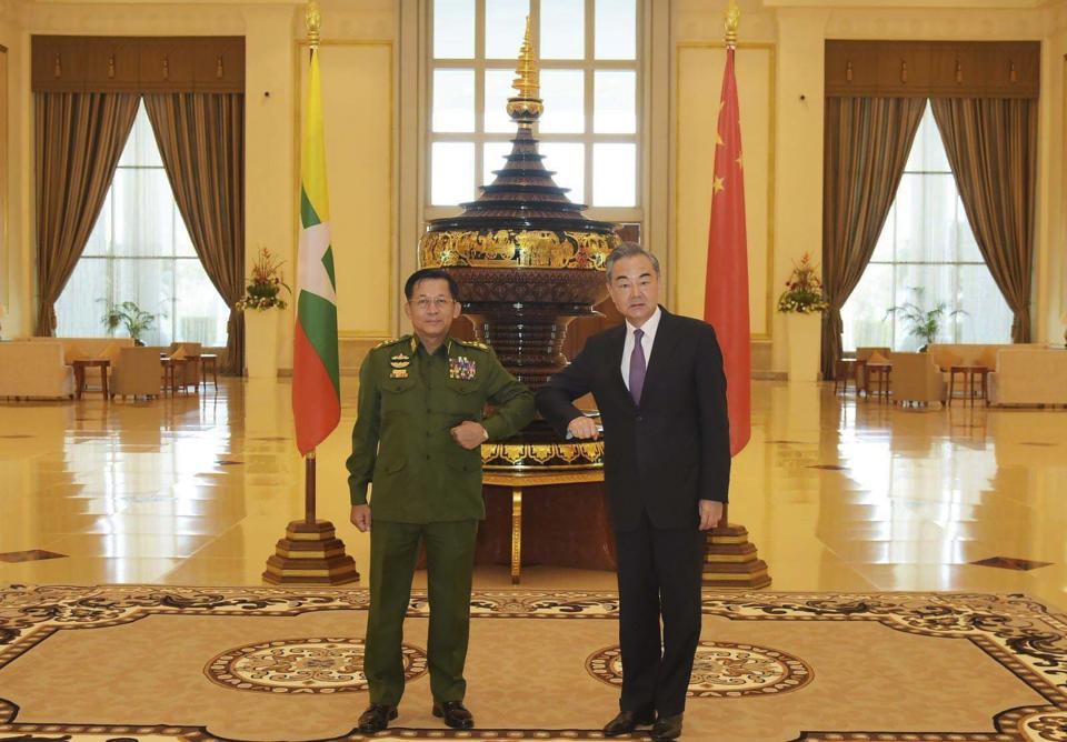 FILE - In this Jan. 12, 2021, file photo provided by Myanmar Military Information Team, Myanmar's Army Commander Senior Gen. Min Aung Hlaing, left, and Chinese Foreign Minister Wang Yi pose for a photo during their meeting in Naypyitaw, Myanmar. The military coup in Myanmar on Monday, Feb. 1, 2021 reflects the leadership's return to leaning on support from Beijing after the international condemnation of the country's treatment of its Rohingya minority. (Myanmar Military Information Team via AP, File)