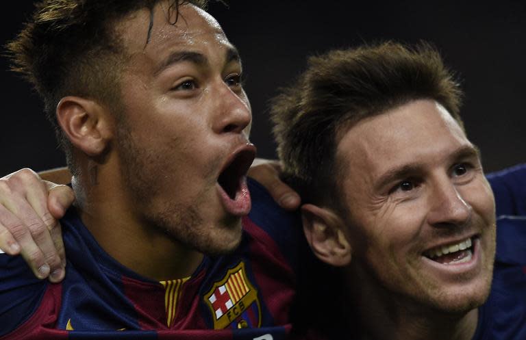 Barcelona's Lionel Messi (R) and Neymar da Silva Santos Junior celebrate after scoring a goal during the Spanish league football match FC Barcelona vs Club Atletico de Madrid in Barcelona on January 11, 2015