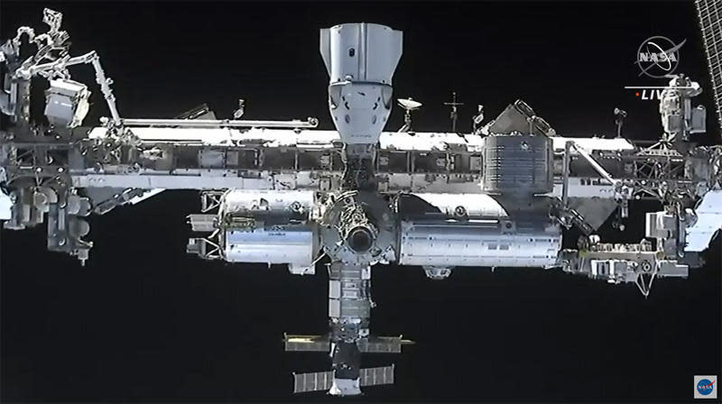 A camera in the nose of the Crew Dragon capsule captures a detailed view of the space station during final approach, including a look at another already-docked Crew Dragon that carried four astronauts to the lab last November. / Credit: NASA TV