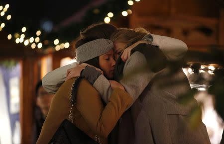 People mourn at the Christmas market at Breitscheid square. REUTERS/Fabrizio Bensch