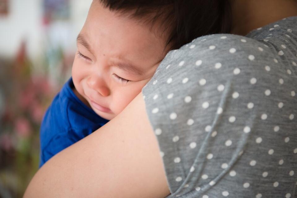 mom holding weaning baby