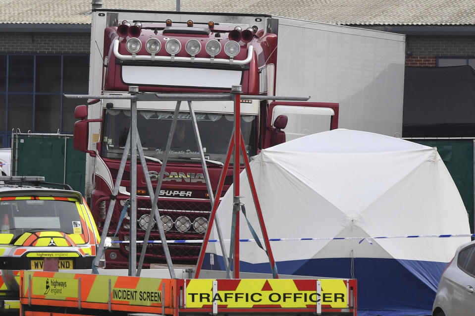 View of a truck, seen in rear, that was found to contain a large number of dead bodies, in Thurrock, South England, early Wednesday Oct. 23, 2019. Police in southeastern England said that 39 people were found dead Wednesday inside the truck container believed to have come from Bulgaria. (Stefan Rousseau/PA via AP)