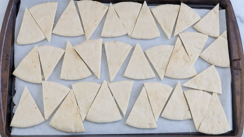 Pita triangles on a baking sheet