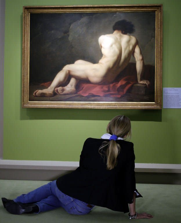 A visitor looks at the painting "Académie d'Homme" by French artist Jacques-Louis David during the "Masculin/Masculin" exhibition at the Orsay Museum on September 23, 2013 in Paris