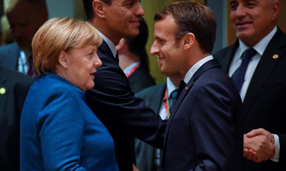 Merkel and Macron greet each other at an EU summit