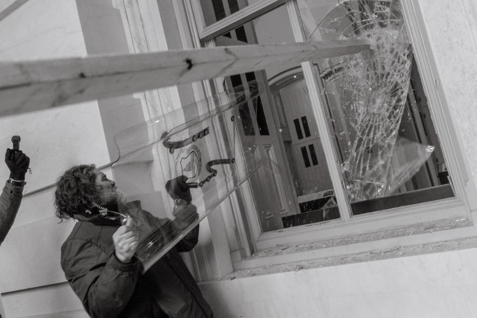 Pro-Trump rioter uses a Capitol Police shield to break a window of the U.S. Capitol in Washington, D.C.<span class="copyright">Christopher Lee for TIME</span>