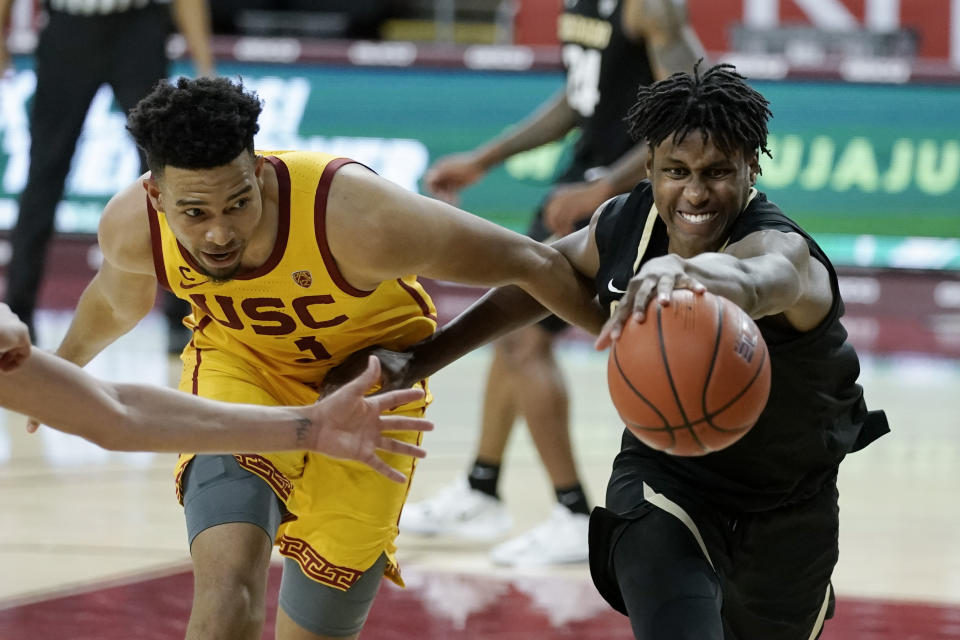 Colorado's Jabari Walker, right, and Southern California's Isaiah Mobley go after a loose ball during the second half of an NCAA college basketball game Thursday, Dec. 31, 2020, in Los Angeles. Colorado won 72-62. (AP Photo/Jae C. Hong)