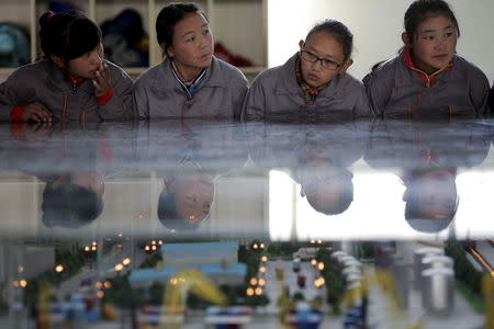 Students listen to their teacher as a group of foreign reporters visits a vocational school on a government organised tour in Lhasa, Tibet Autonomous Region, China in this November 19, 2015 file photo. REUTERS/Damir Sagolj/Files