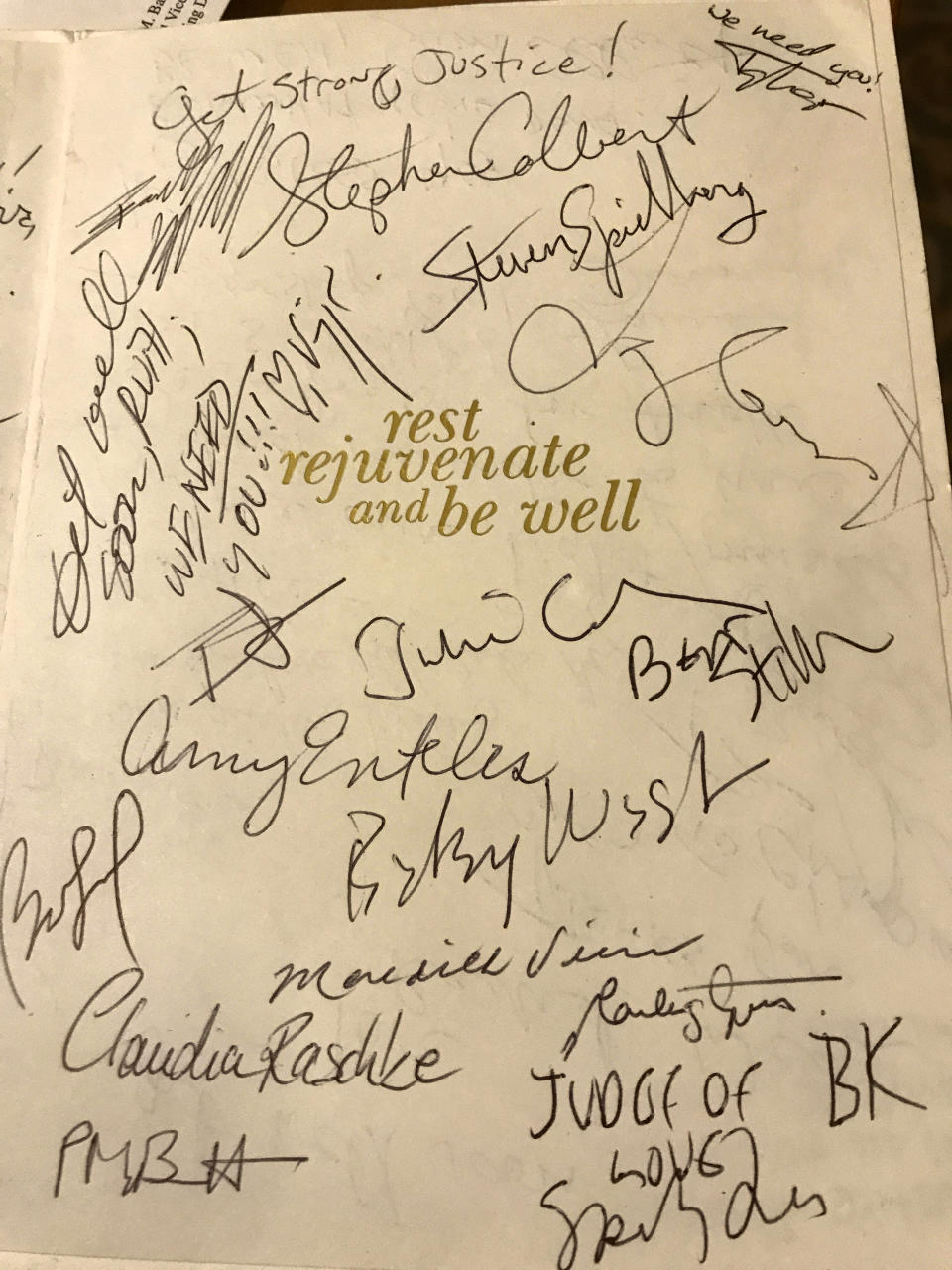 This image released by Magnolia Pictures shows celebrity signatures on a get well card meant for U.S. Supreme Court Justice Ruth Bader Ginsburg. Filmmakers from the Oscar nominated "RBG" film have been collecting signatures and get-well notes from Hollywood A-listers for Ginsburg, who is recovering from lung cancer surgery. (Magnolia Pictures via AP)