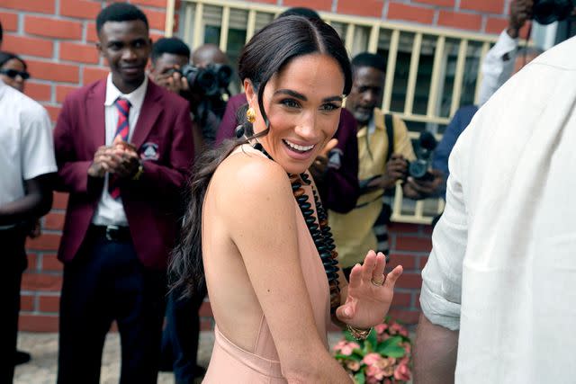 <p>AP Photo/Sunday Alamba</p> Meghan Markle at the Lightway Academy in Abuja, Nigeria