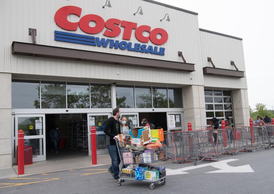 Shoppers walk out with full carts from a Costco store in Washington, DC, on May 5, 2020. - Big-box retailer Costco is limiting consumer purchases of meat in the wake of shutdowns of US processing plants due to the coronavirus.Costco, which has about 440 stores in the United States, is limiting purchases to three items among beef, pork and poultry products, the company said on its website. (Photo by Nicholas Kamm / AFP) (Photo by NICHOLAS KAMM/AFP via Getty Images)