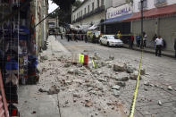 Security tape alert people of a building damaged by an earthquake in Oaxaca, Mexico, Tuesday, June 23, 2020. The earthquake was centered near the resort of Huatulco, in the southern state of Oaxaca. (AP Photo/Luis Alberto Cruz Hernandez)