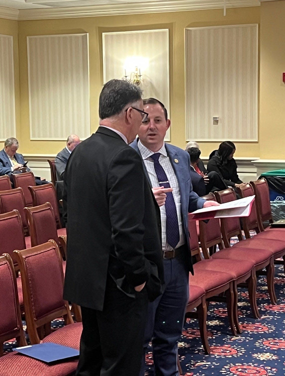 At left, state Sen. Johnny Ray Salling, R-Baltimore County, listens to Senate President Bill Ferguson, at right, before testifying before the Senate Finance Committee in Annapolis on April 2, 2024 on legislation intended to help those affected by the bridge collapse. “We cannot do this without us working together as a team,” said Salling, during the hearing.