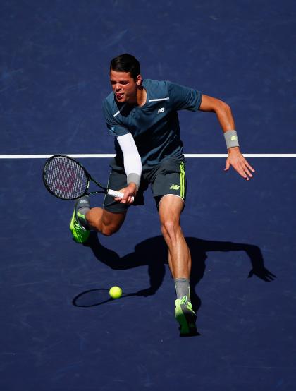 Raonic spent some time at the net against Roger Federer. But probably not enough. (Photo by Julian Finney/Getty Images)