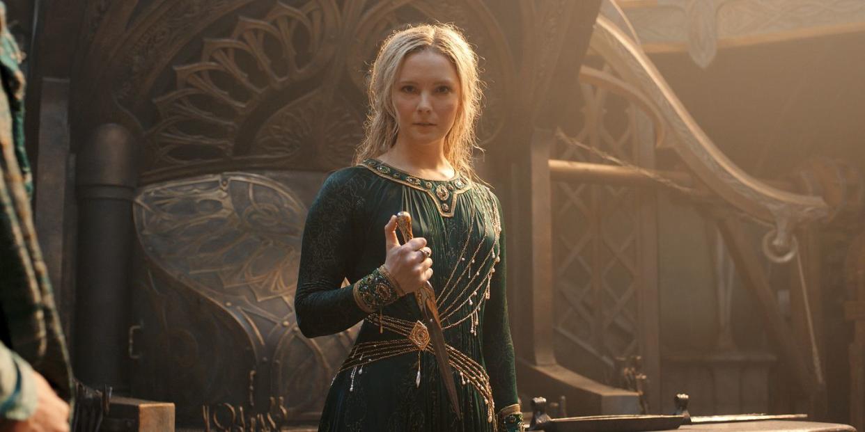 morfydd clark as galadriel in a green dress holding a dagger, lord of the rings the rings of power