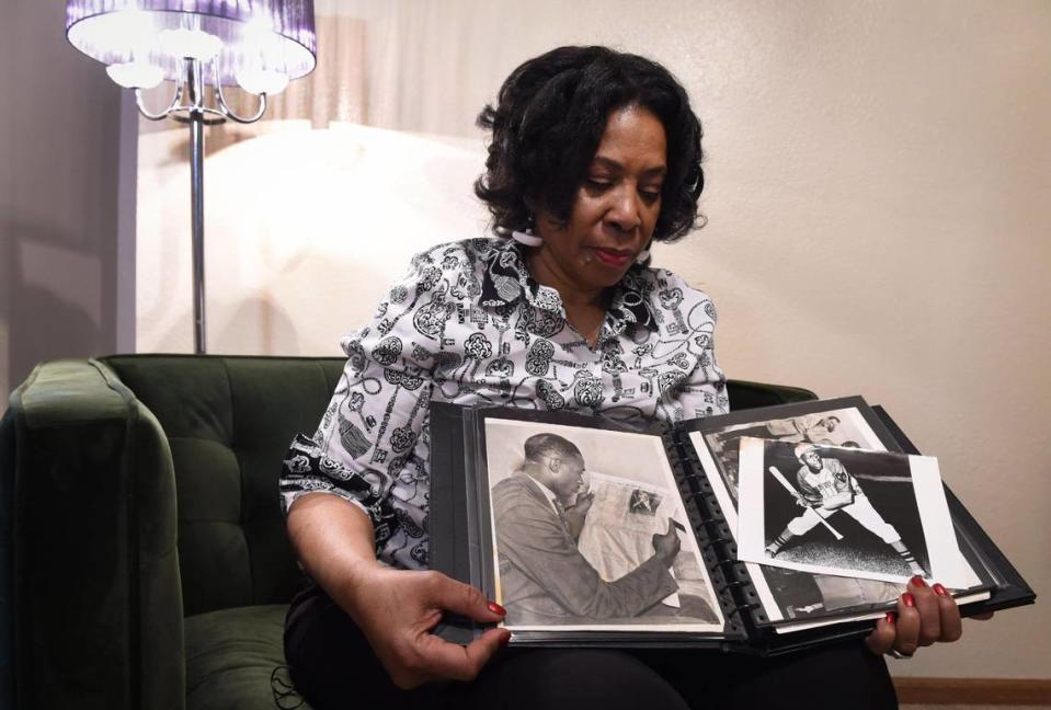 Linda Shelby, daughter of Hall of Fame pitcher Satchel Paige, looks over a scrapbook filled with photos of her father.