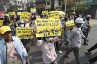 FILE - Anti-coup protesters display signs during a protest against the military coup in Mandalay, Myanmar, Monday, March 15, 2021. The prospects for peace in Myanmar, much less a return to democracy, seem dimmer than ever two years after the army seized power from the elected government of Aung San Suu Kyi, experts say. (AP Photo, File)