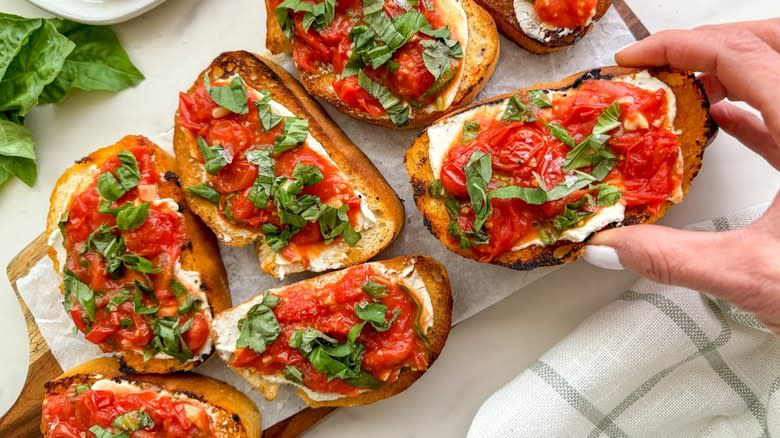 tomato bruschetta on a wood cutting board