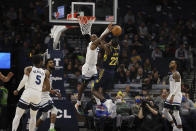 Indiana Pacers guard Caris LeVert (22) goes up to the basket against Minnesota Timberwolves guard Jaylen Nowell (4) during the first half of an NBA basketball game Monday, Nov. 29, 2021, in Minneapolis. (AP Photo/Stacy Bengs)