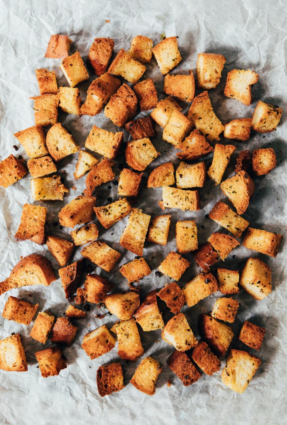 Homemade croutons on a baking sheet.