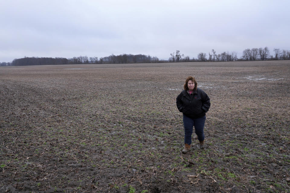 Clara Ostrander walks in her family's field in Maybee, Mich., Tuesday, Jan. 9, 2024. The family sought to lease some of the property for a solar energy project that would have paid enough to help them keep their land. Local opposition tanked the project and Ostrander now says there are neighbors she will never speak to again. (AP Photo/Paul Sancya)