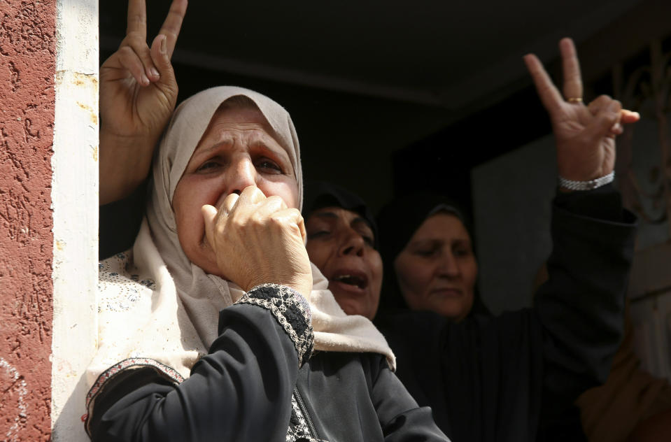 Relatives react while mourners carry the body of Jihad Hararah, in front of his family house during his funeral in Shijaiyah neighborhood in Gaza City, Saturday, March 23, 2019. Gaza's Health Ministry said Hararah, died shortly after he shot at his face yesterday by Israeli troops during a protest at the Gaza Strip's border with Israel. (AP Photo/Adel Hana)