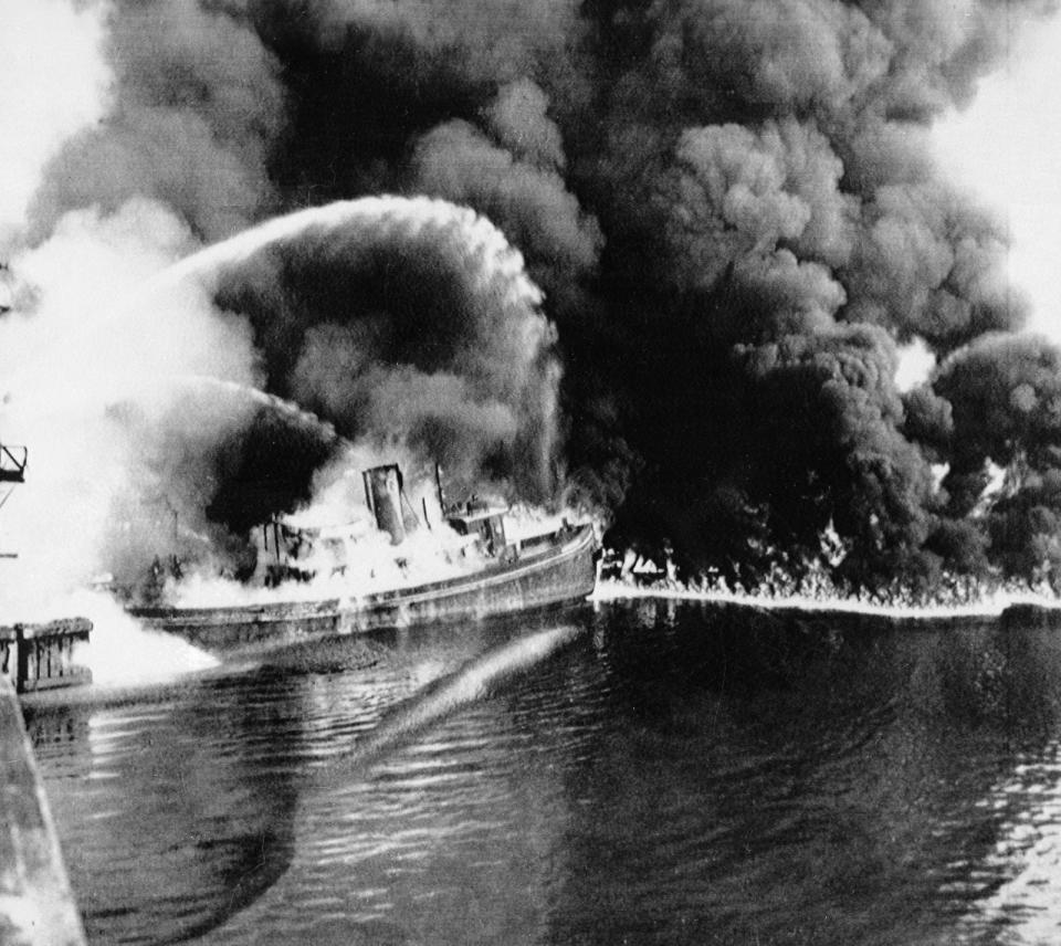 FILE - In this June 25, 1952 file photo, a fire tug fights flames on the Cuyahoga River near downtown Cleveland. Federal environmental regulators say fish living in the northeastern Ohio river are now safe to eat. The easing of fish consumption restrictions on the Cuyahoga River was lauded by Republican Gov. Mike DeWine as progress achieved by investing in water quality.(The Plain Dealer via AP)