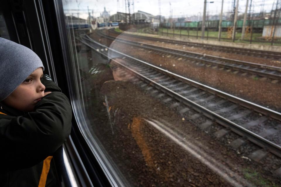 Sergei looks out of the window of a train minutes before arriving with his family in Lviv, from Kyiv, Ukraine, on April 17, 2022.