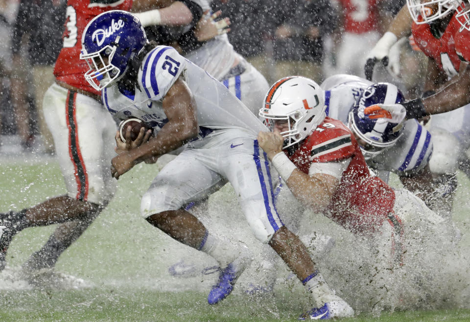 Miami defensive lineman Scott Patchan (19) attempts to tackle Duke running back Mataeo Durant (21) during the first half of an NCAA college football game Saturday, Nov. 3, 2018, in Miami Gardens, Fla. (AP Photo/Lynne Sladky)