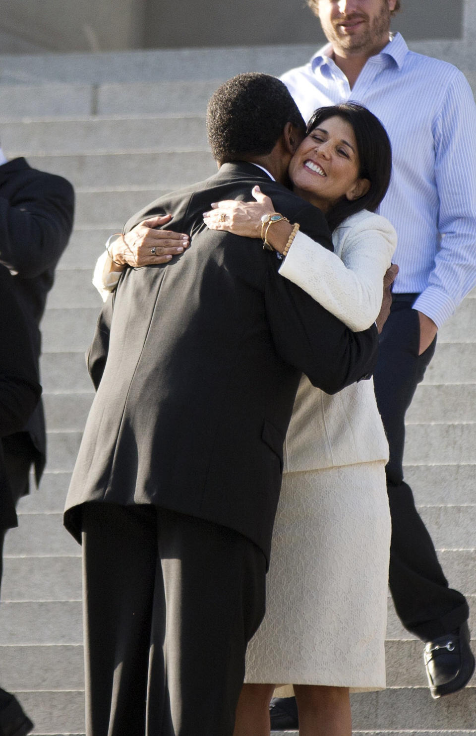 South Carolina Gov. Nikki Haley hugs Rev. Norvel Goff, interim pastor at Emanuel AME Church in Charleston, before an honor guard from the South Carolina Highway Patrol removed the Confederate battle flag from the Capitol grounds, Friday, July 10, 2015, in Columbia, South Carolina.