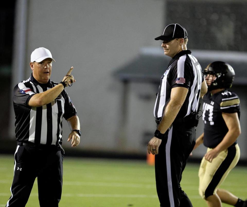 One official looks on as another calls a penalty in the second half of an UIL football game at Keller ISD Stadium in Keller, Texas, Thursday Aug. 31, 2023.