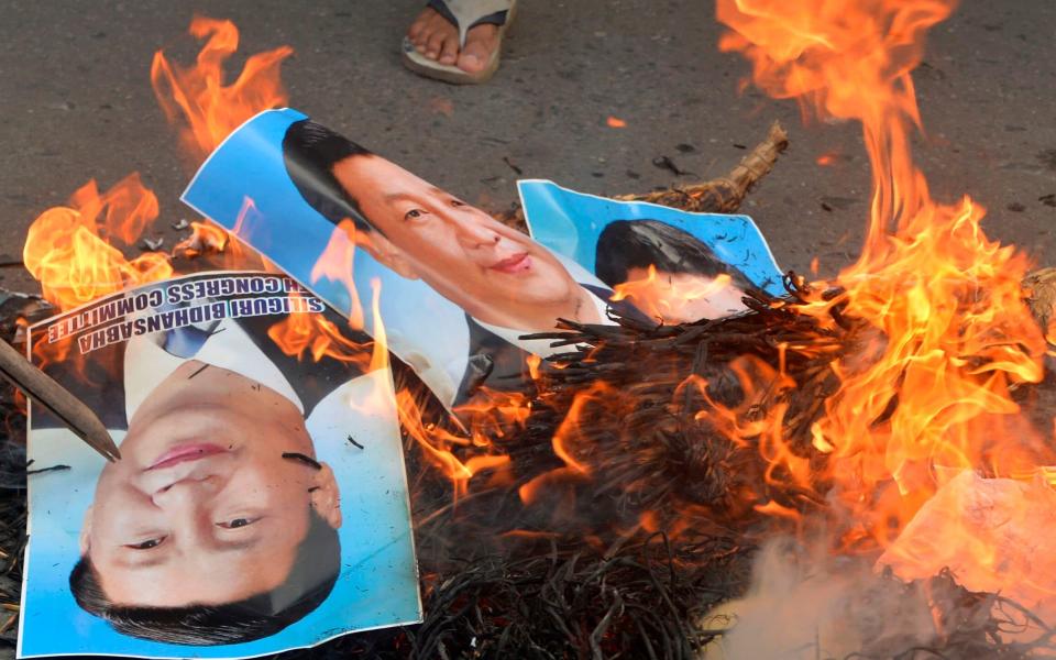 Images of Mr Xi were burnt in Siliguri - DIPTENDU DUTTA/AFP via Getty Images