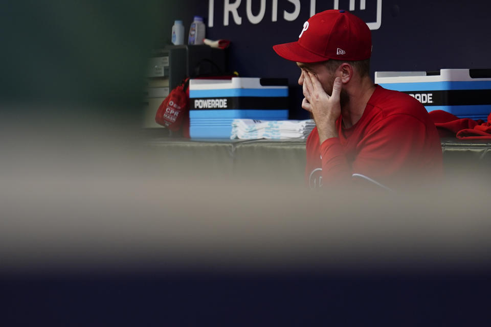 Philadelphia Phillies starting pitcher Dylan Covey (54) wipes his eyes in the dugout after being taken out of a baseball game in the first inning against the Atlanta Braves, Sunday, May 28, 2023, in Atlanta. (AP Photo/Brynn Anderson)