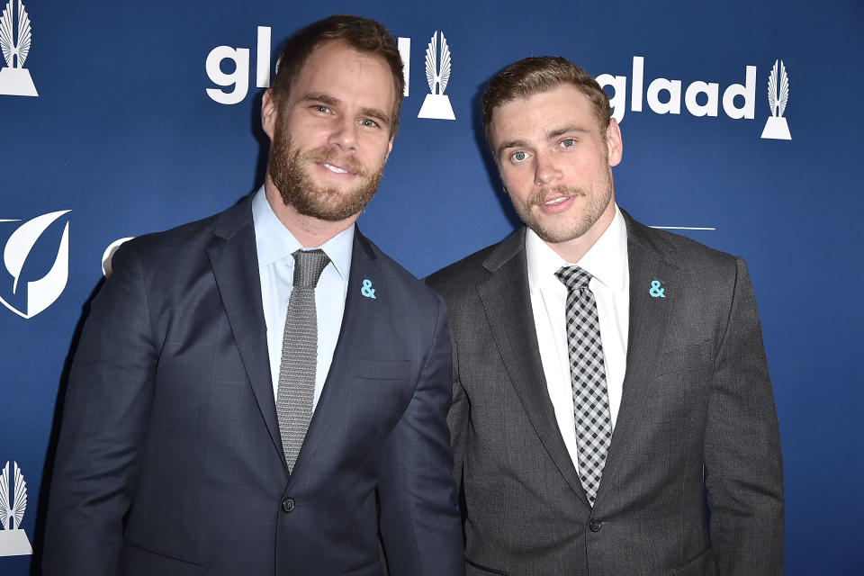 Close-up of Matthew and Gus in suits and ties at a media event