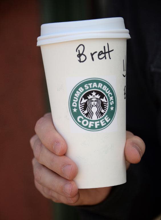 A man holds his coffee outside "Dumb Starbucks" on February 10, 2014, in the Los Feliz area of Los Angeles