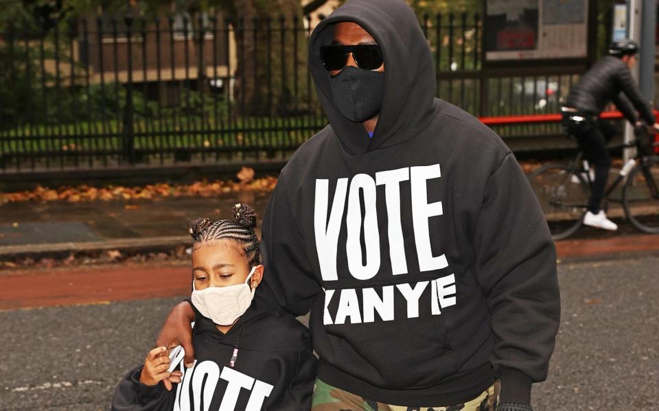 Kanye West with his daughter North, in London in October - Getty