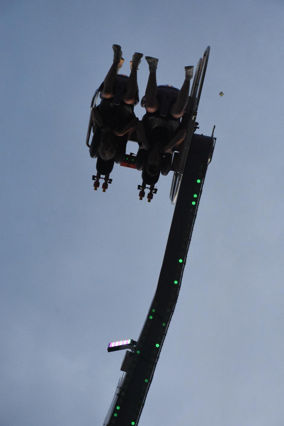 A bundle of cash flies out of a rider's pocket on the Jekyll & Hyde ride at the Williamson County Fair in Franklin, Tenn. Monday, Aug. 8, 2022.