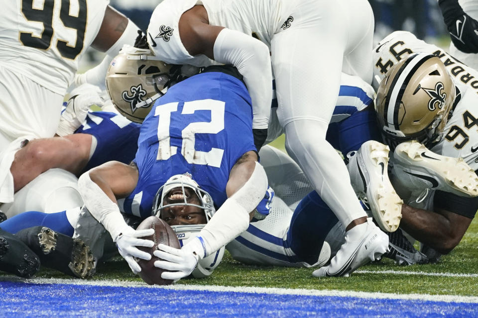 Indianapolis Colts running back Zack Moss (21) reaches for a one-yard touchdown run against the New Orleans Saints during the first half of an NFL football game Sunday, Oct. 29, 2023 in Indianapolis. (AP Photo/Michael Conroy)