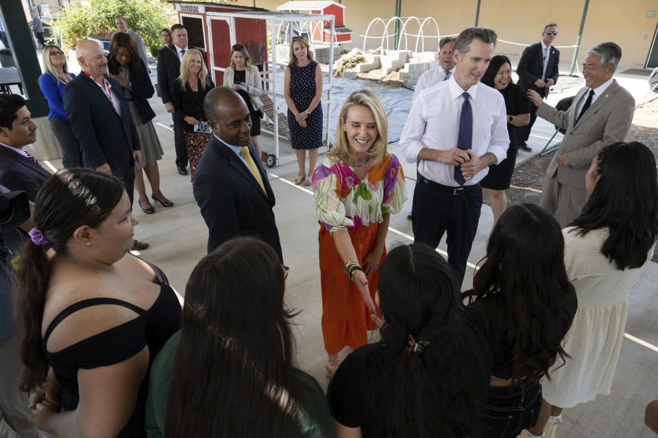 FILE - California First Partner Jennifer Siebel Newsom, center, greets a student while she stands with state Superintendent of Public Instruction Tony Thurmond and Gov. (Paul Kitagaki Jr./The Sacramento Bee via AP, Pool, File)