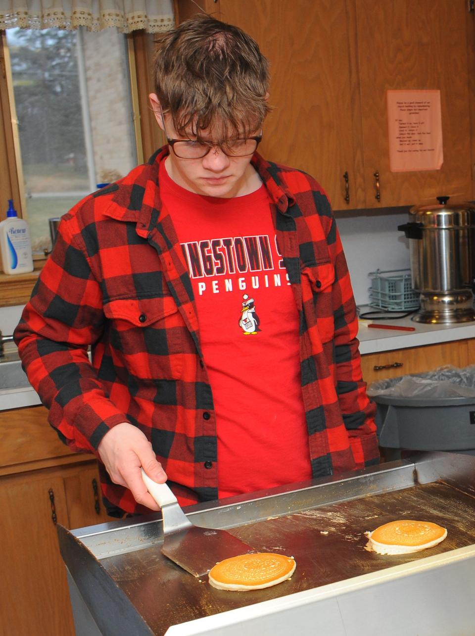 Joseph Sprague cooks pancakes during the monthly breakfast Saturday, Jan. 15, 2022, at Damascus United Methodist Church. The church accepts donations for the breakfast to sponsor a summer mission trip. The trip will assist Jackson Area Ministries in Jackson, Ohio.