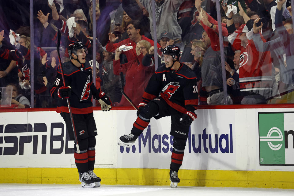 Carolina Hurricanes' Sebastian Aho (20), with teammate Brady Skjei (76) nearby, celebrates after his tying goal during the third period in Game 2 of an NHL hockey Stanley Cup first-round playoff series against the New York Islanders in Raleigh, N.C., Monday, April 22, 2024. (AP Photo/Karl B DeBlaker)