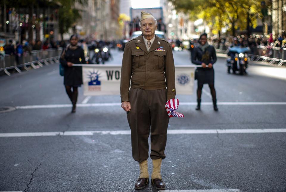 World War II Army veteran poses for a photograph as he marches in the New York City Veterans Day parade on 5th Avenue in New York