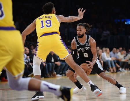 October 22, 2018; Los Angeles, CA, USA; San Antonio Spurs guard Patty Mills (8) moves the ball against Los Angeles Lakers forward Johnathan Williams (19) during the second half at Staples Center. Mandatory Credit: Gary A. Vasquez-USA TODAY Sports