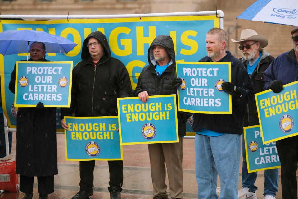 Letter carriers hold signs at a press conference on the south plaza of the Oklahoma Capitol, Thursday, Feb. 29, 2024.